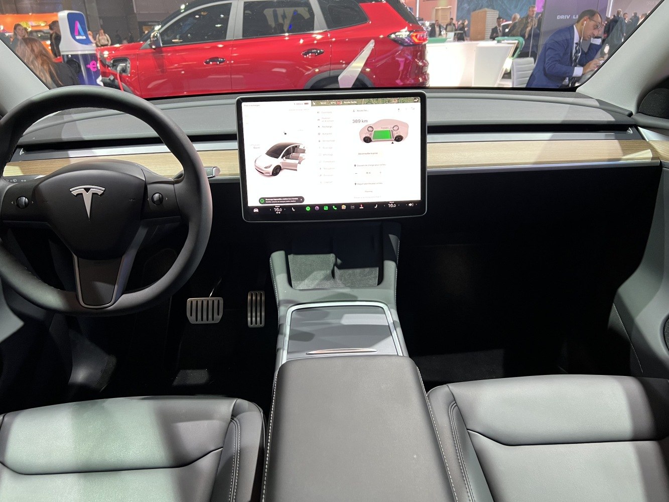 Minimalistic dashboard with large central touchscreen and steering wheel