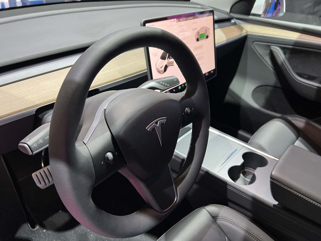 Innovative steering wheel with central touchscreen and minimalist dashboard.