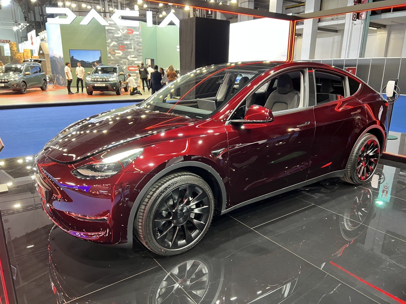Glossy dark red electric SUV with sleek black alloy wheels