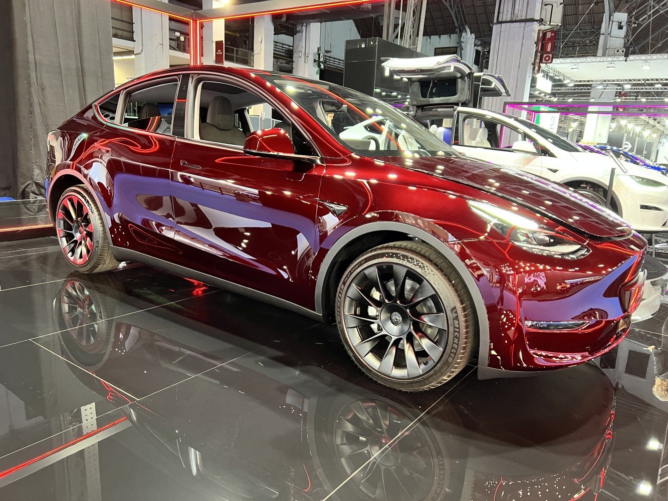 Sleek red electric SUV with aerodynamic styling and black alloy wheels