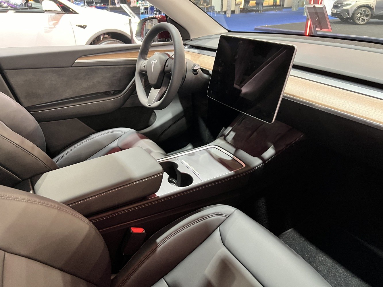 Minimalist dashboard with a large touchscreen and wood trim