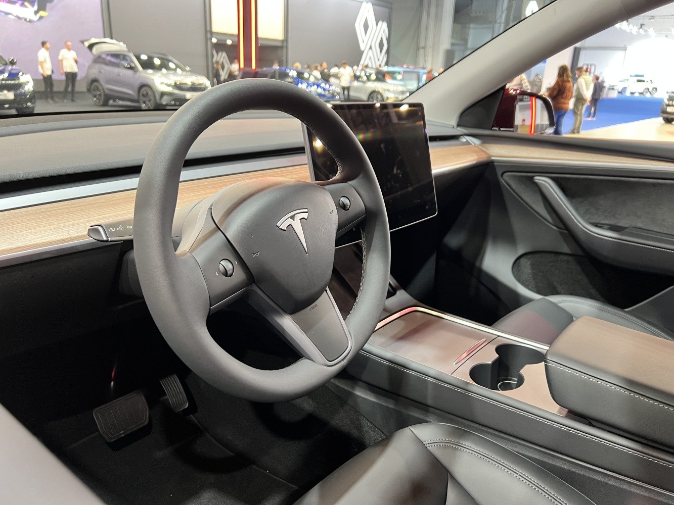 Minimalist dashboard with touchscreen and Tesla steering wheel