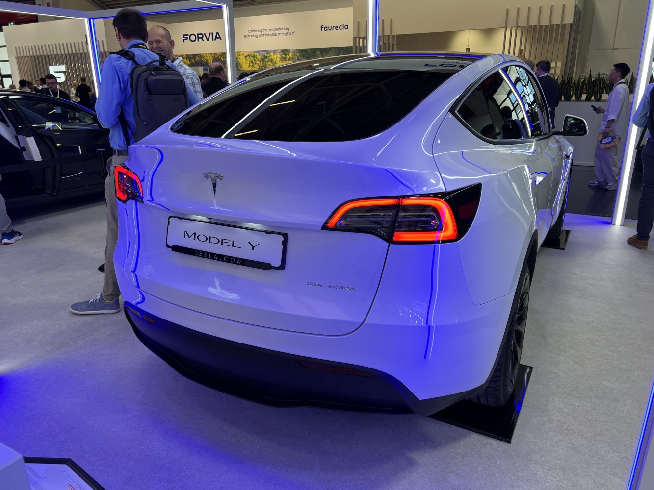 Rear view of electric vehicle with illuminated LED tail lights and smooth aerodynamic design