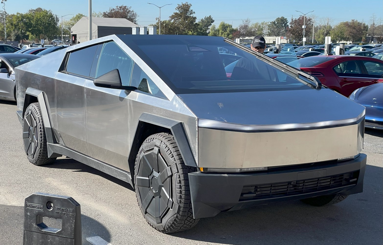 Futuristic angular electric pickup with stainless steel body and polygonal wheels