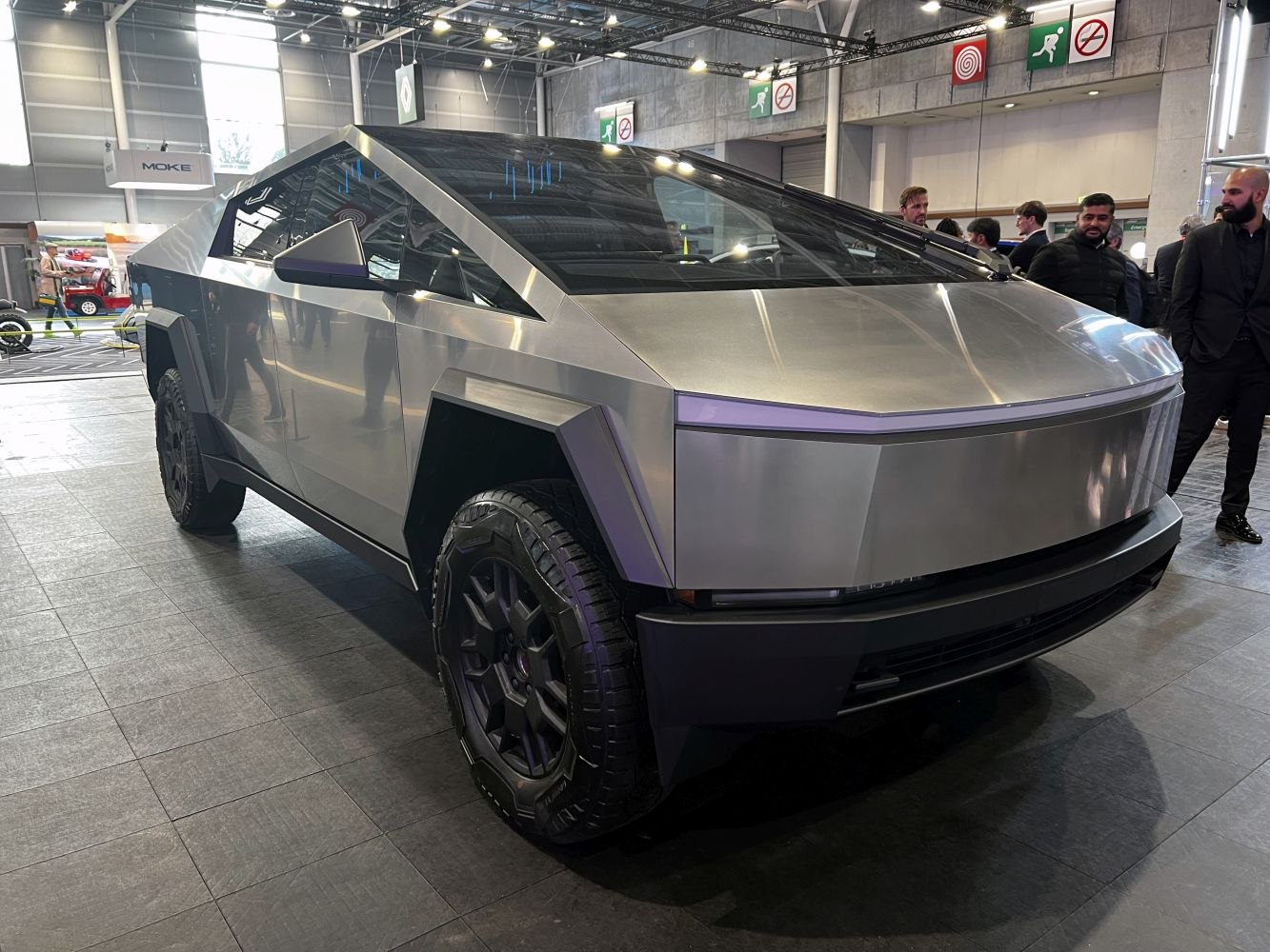 Angular stainless steel electric pickup with off-road tires