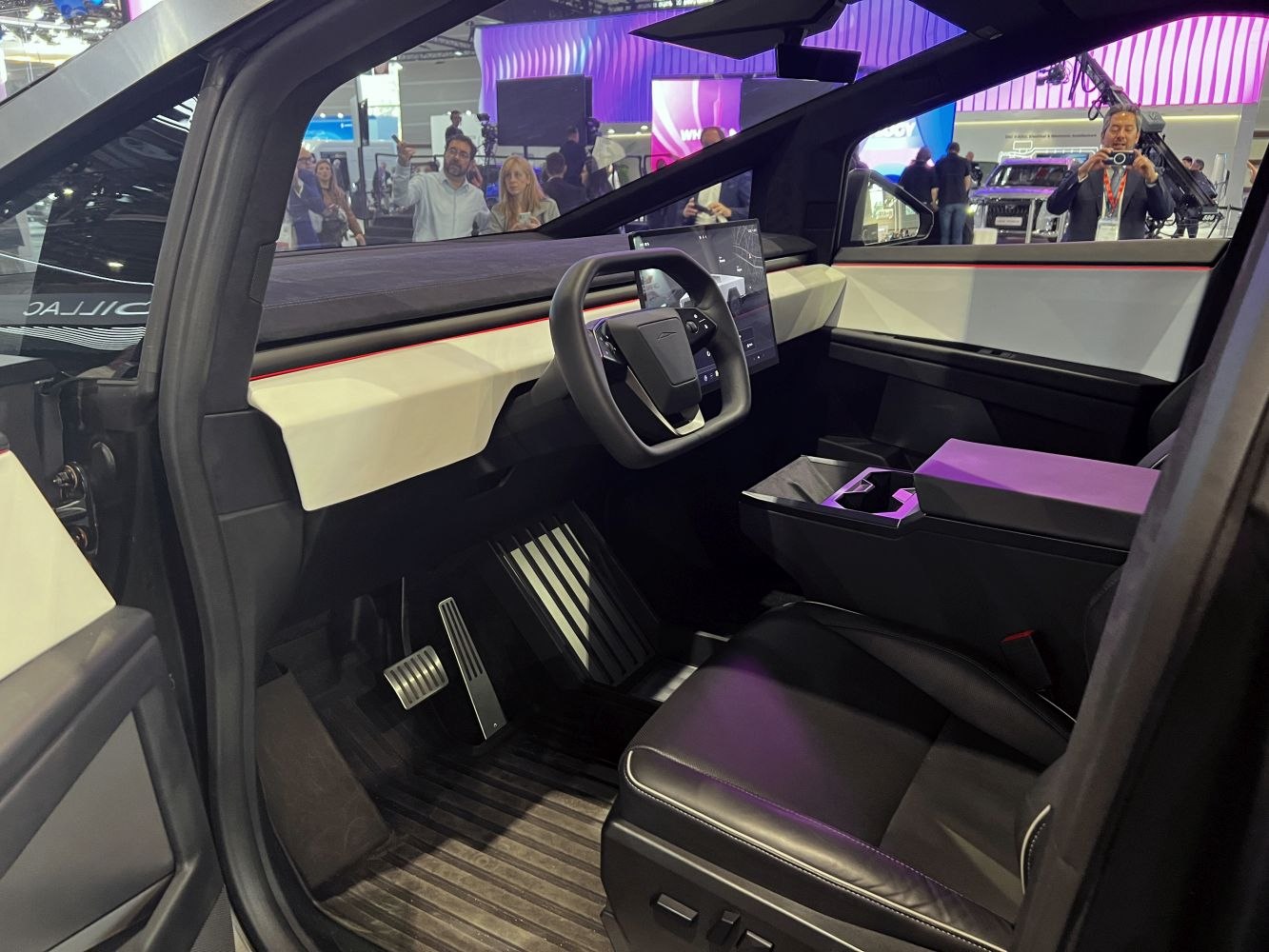Futuristic truck interior with yoke steering wheel and large touchscreen