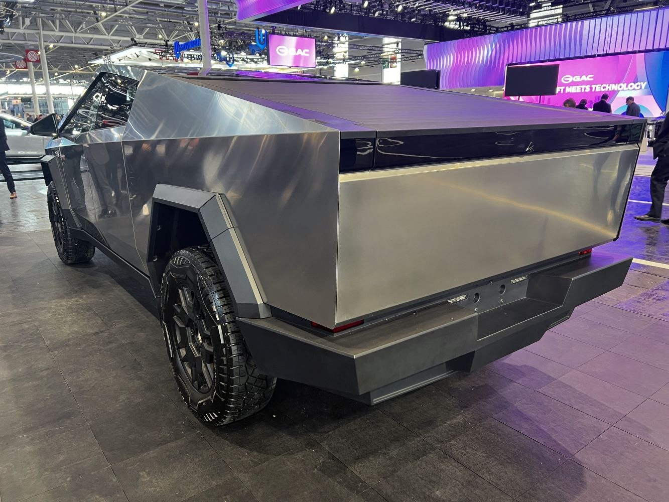 Sharp angular electric pickup truck with covered flat bed and off-road tires