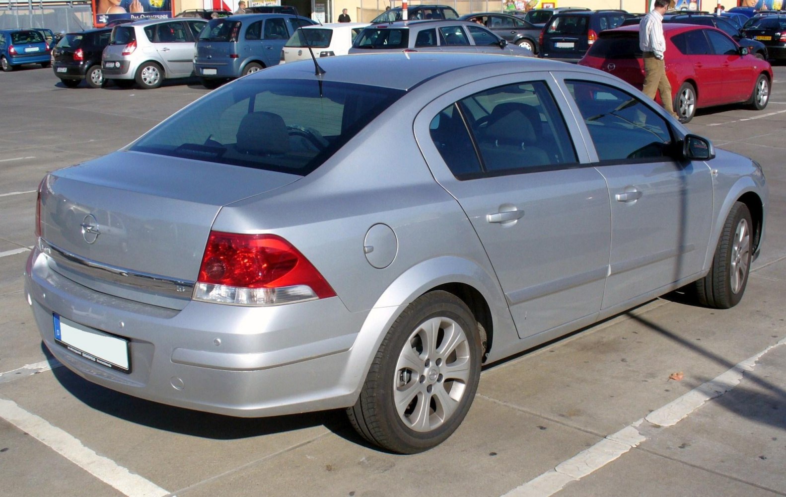 Silver mid-size sedan rear side view with taillights and alloy wheels
