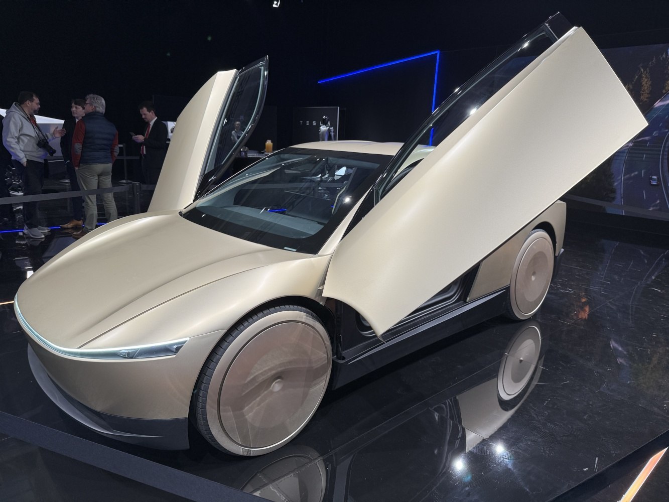 Futuristic gullwing doors and unique covered wheels on a sleek concept vehicle