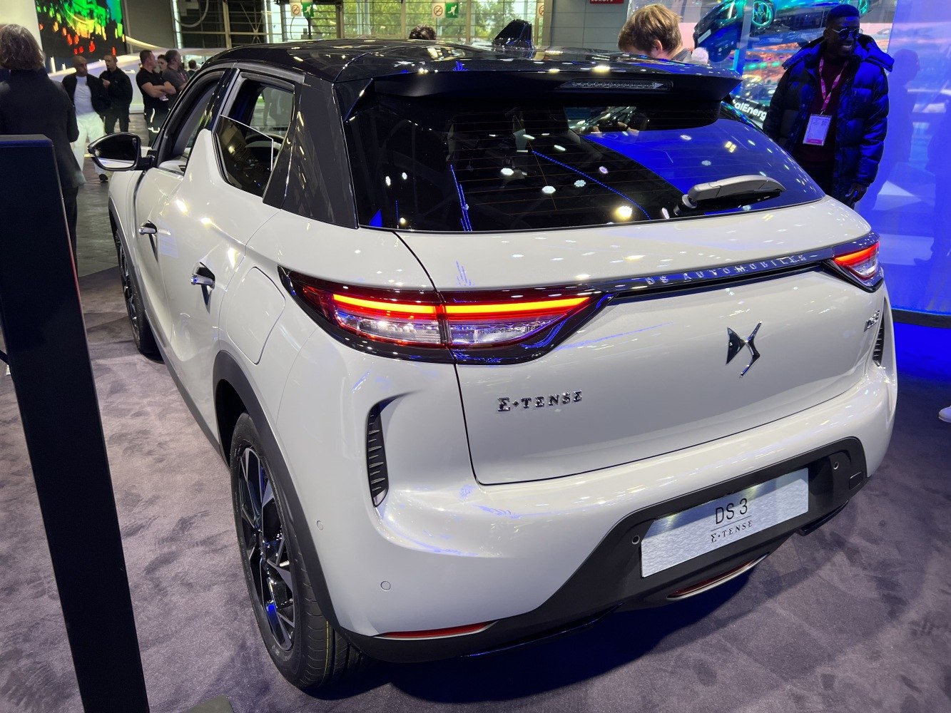 Rear view with illuminated taillights and black roof