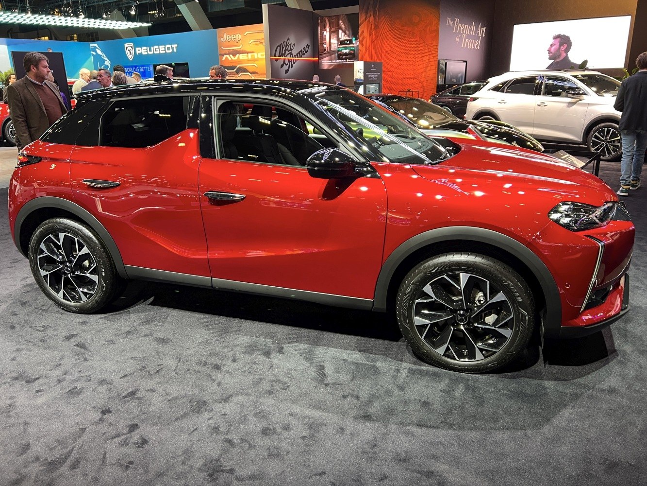 Compact SUV with black roof and multi-spoke alloy wheels in showroom