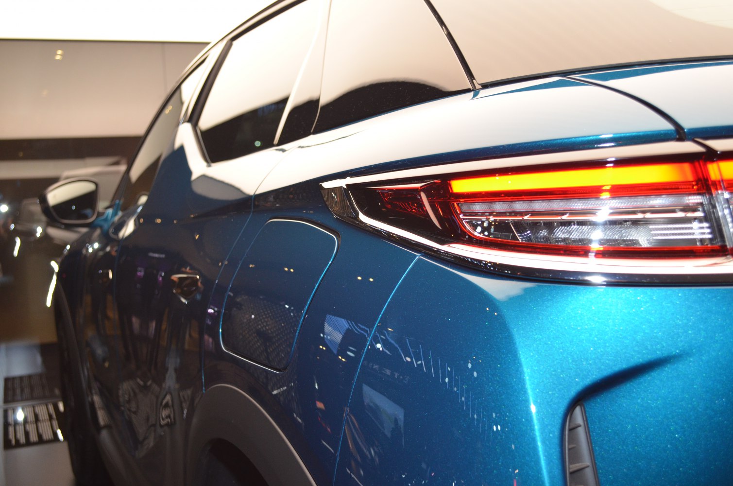 Close-up of rear side and tail light with blue body paint