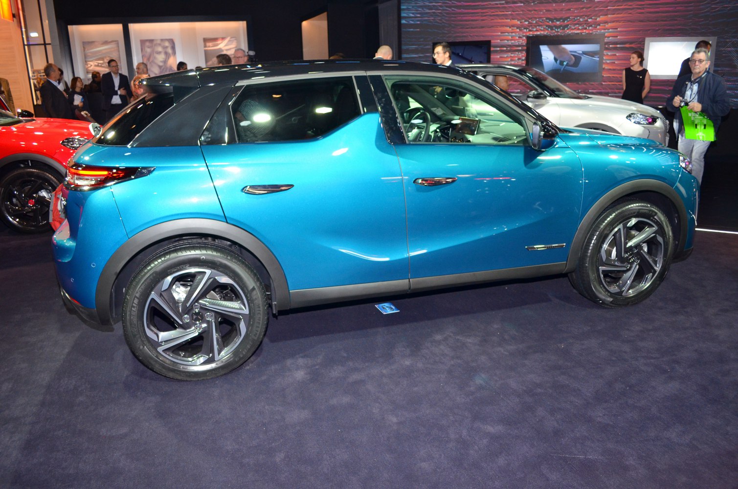 Side view of a blue compact SUV with distinctive rear and alloy wheels