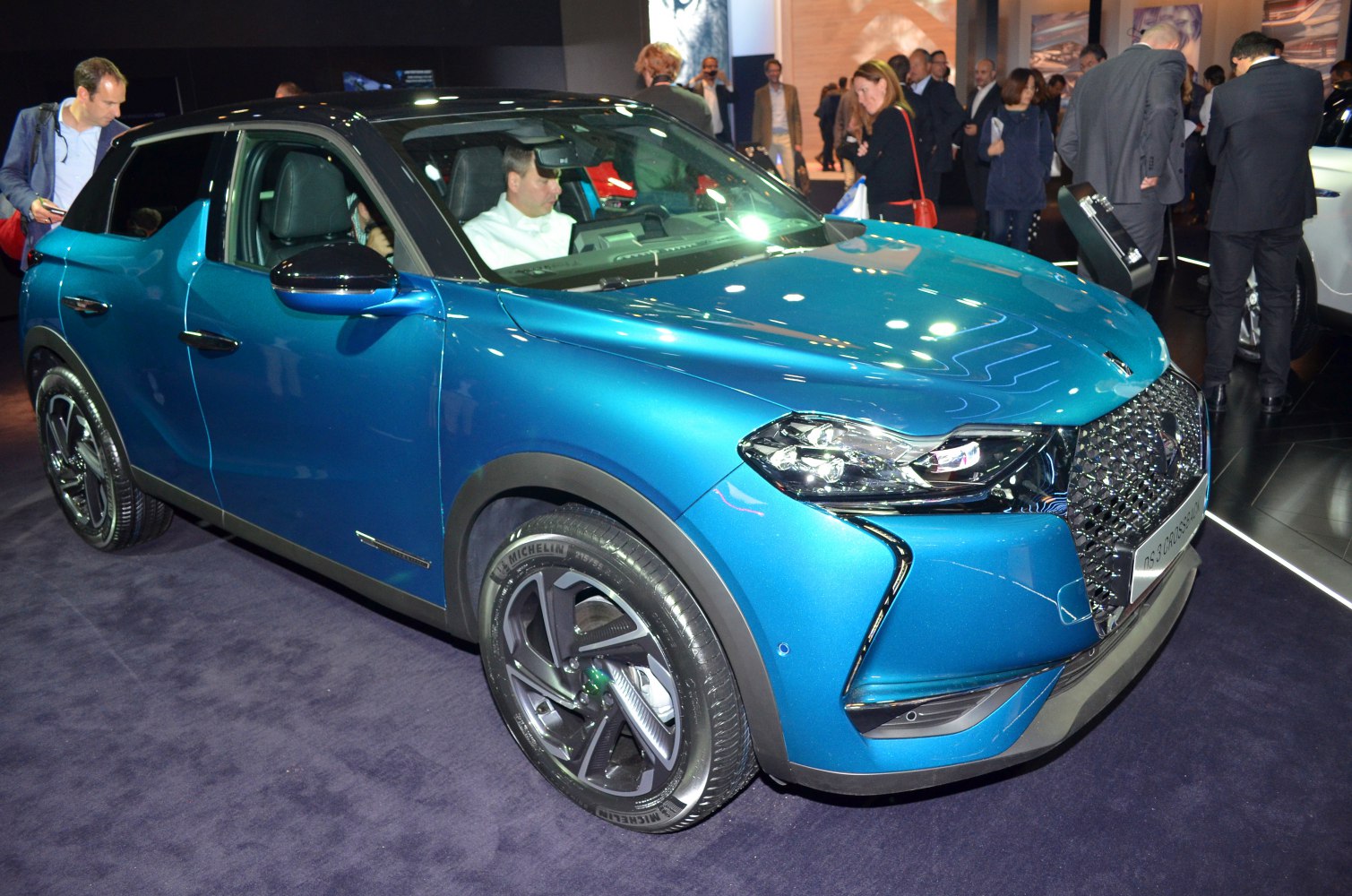 Blue compact crossover with LED headlights and black roof