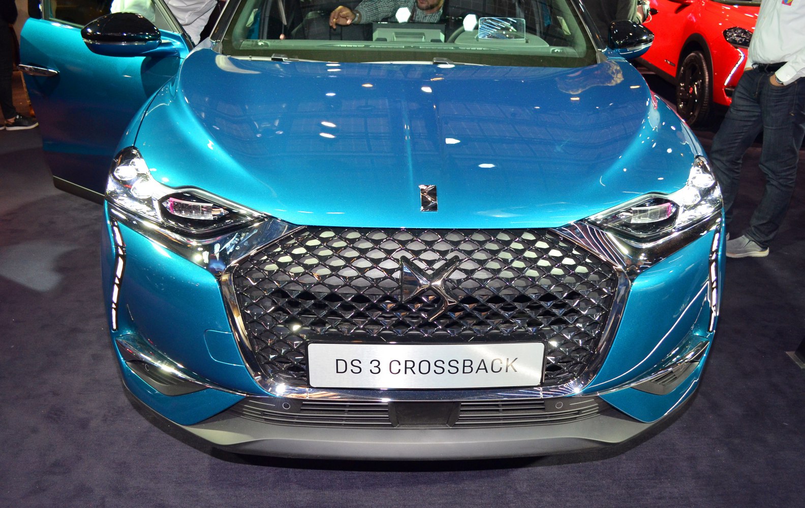 Close-up of front grille and LED headlights in blue vehicle