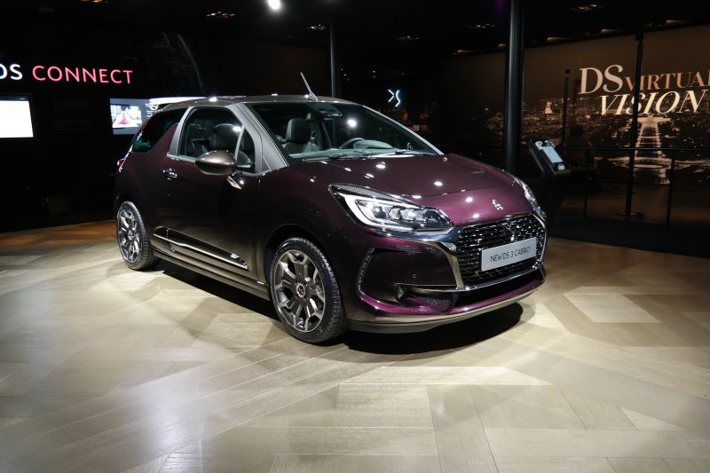 Front view of compact convertible with illuminated headlights and sporty alloy wheels