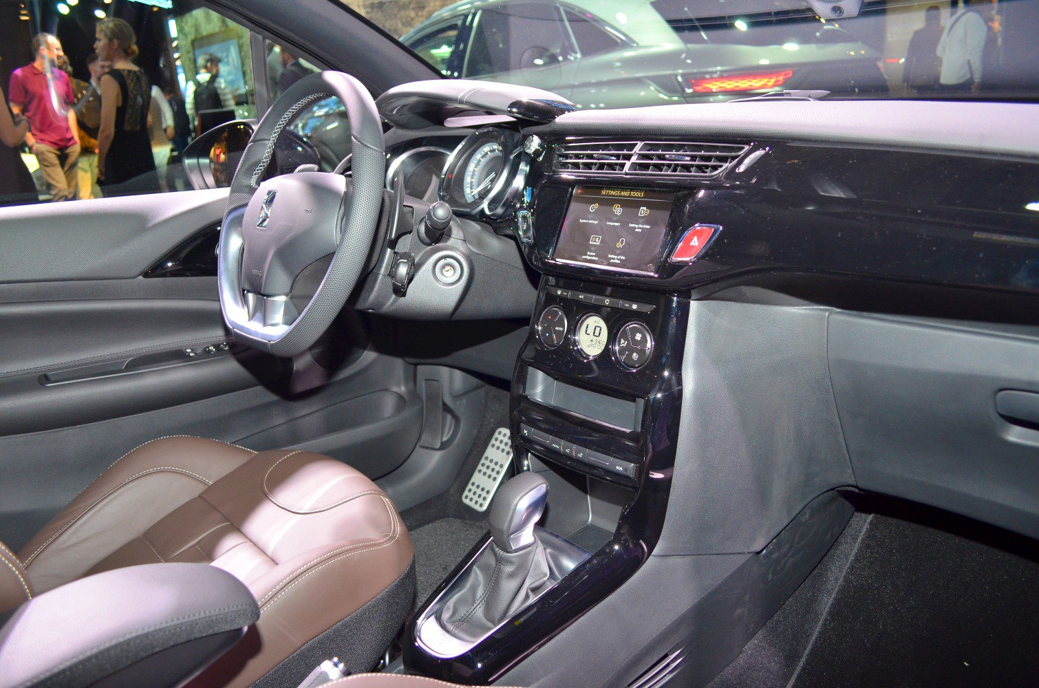 Steering wheel, dashboard with touchscreen, and climate control panel.