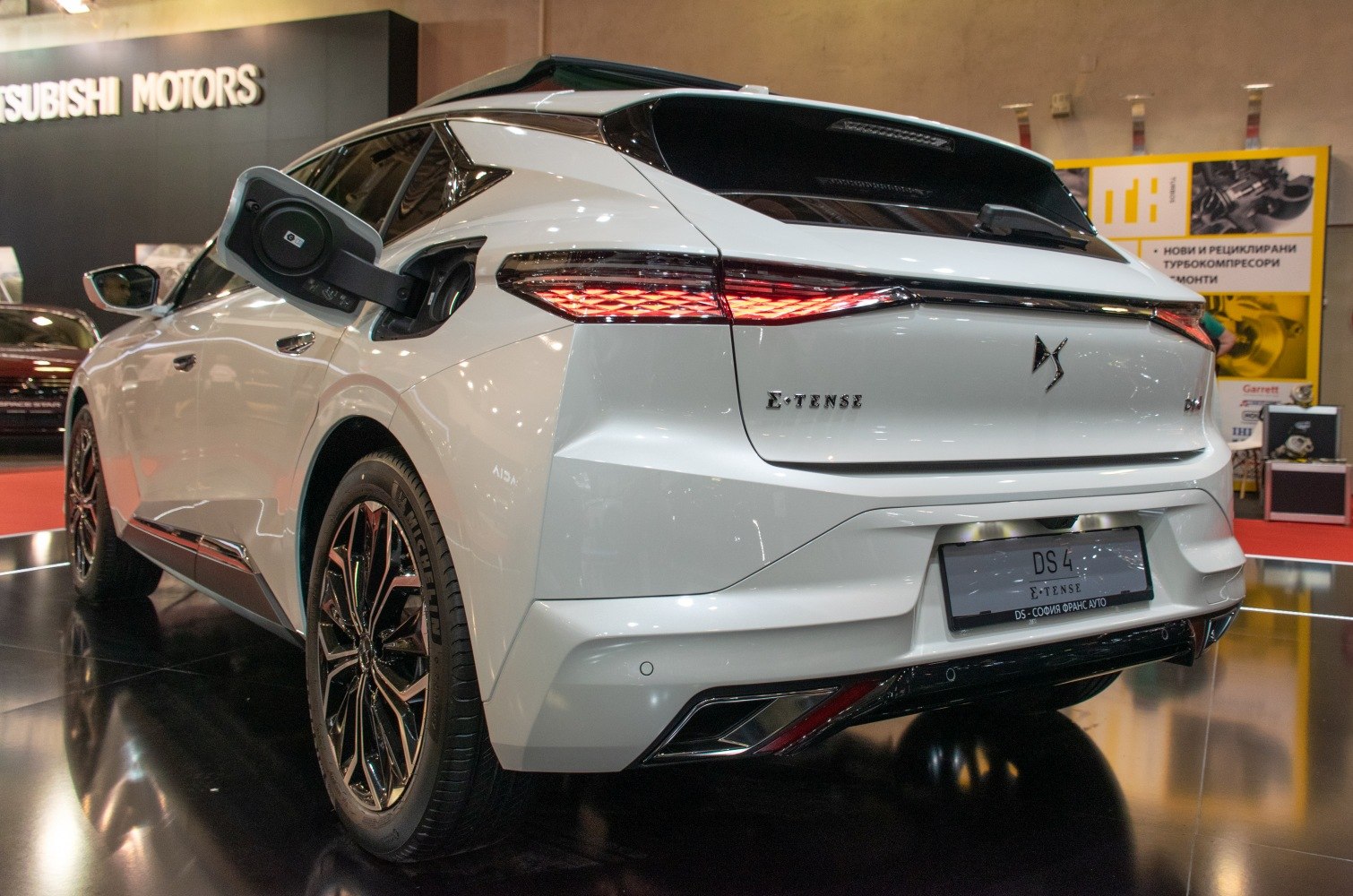 Rear view with illuminated taillights and open charging port