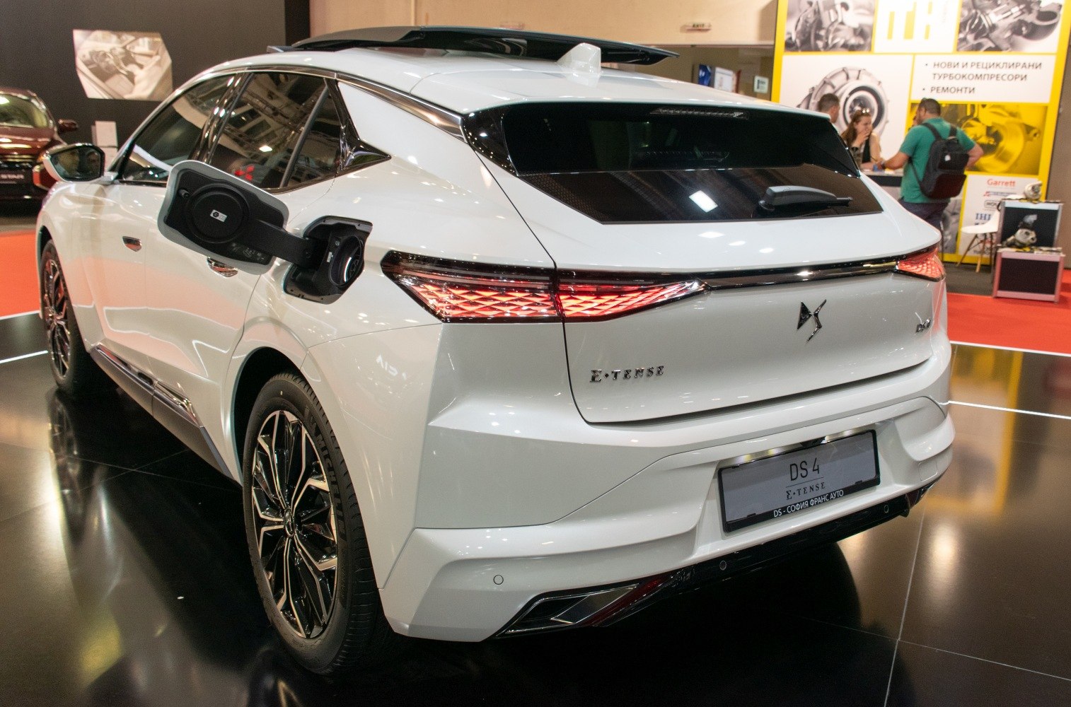 Rear view with electric charging port and illuminated sleek tail lights