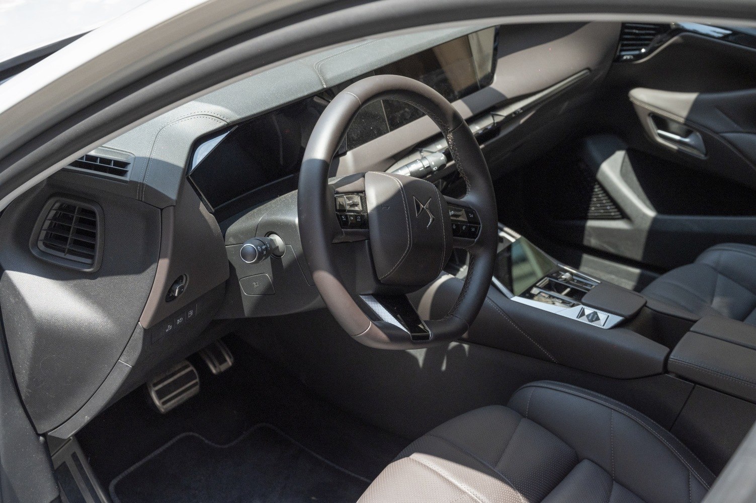Modern steering wheel and digital dashboard with sleek controls