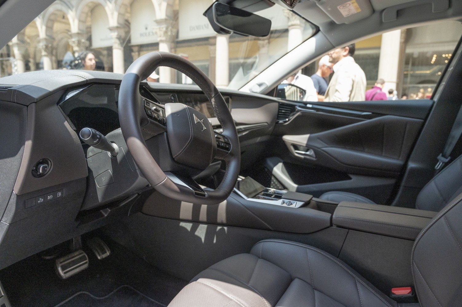 Steering wheel, dashboard, and front seats in modern car interior