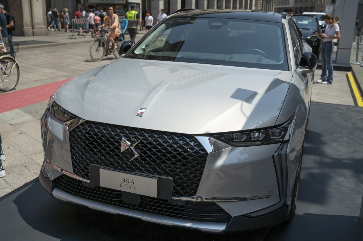 Mesh grille and angular LED headlights on front view.