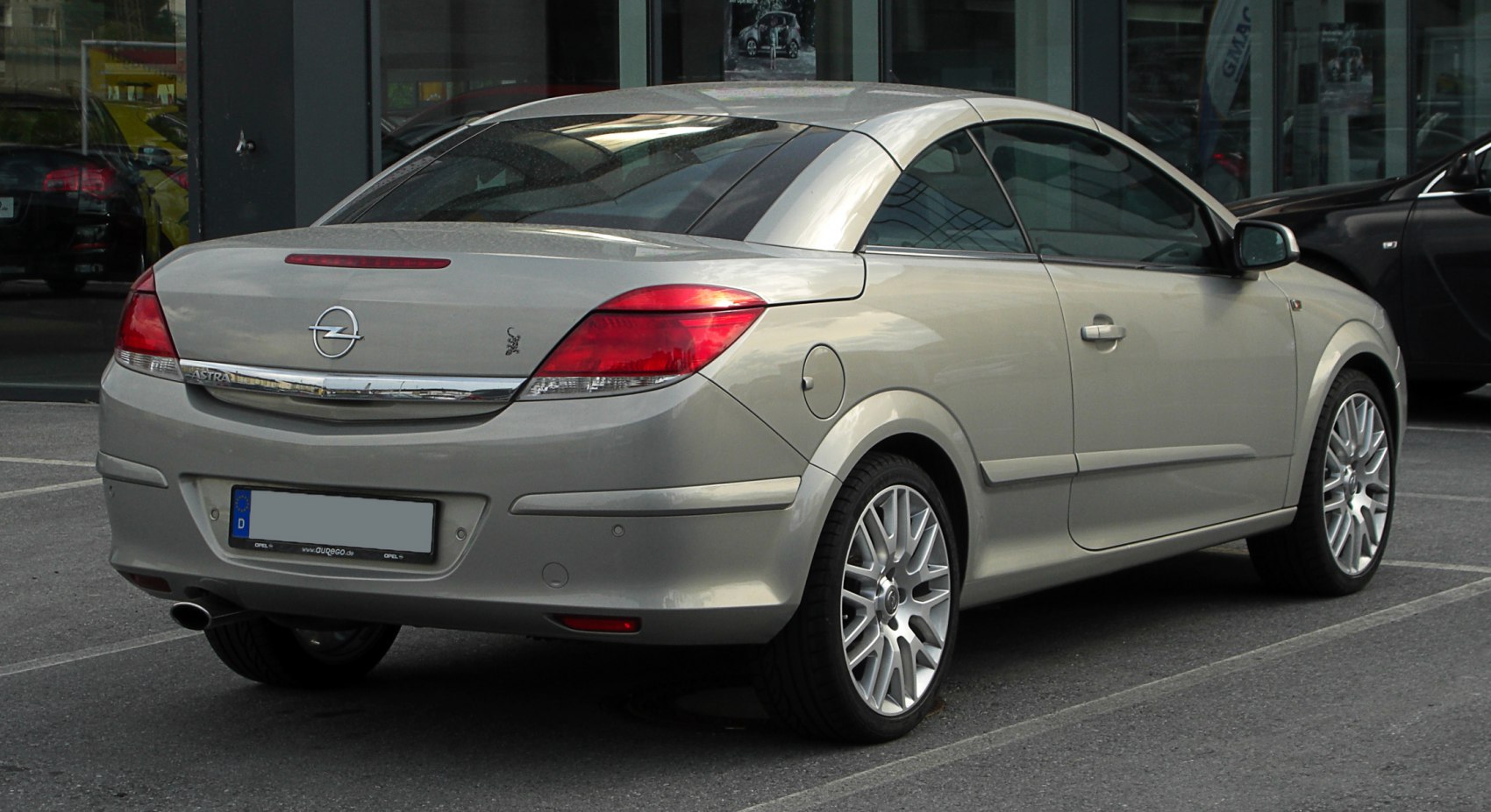 Rear view of convertible with alloy wheels and sleek tail light design