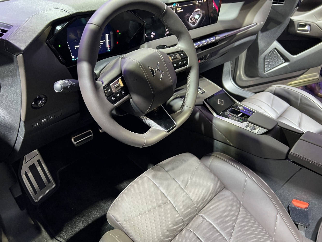 Luxury car interior with digital dashboard and ergonomic steering wheel