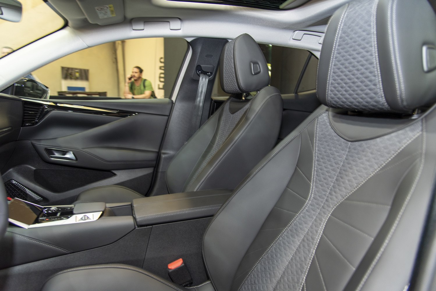 Luxury car seats with detailed stitching and door panel design.