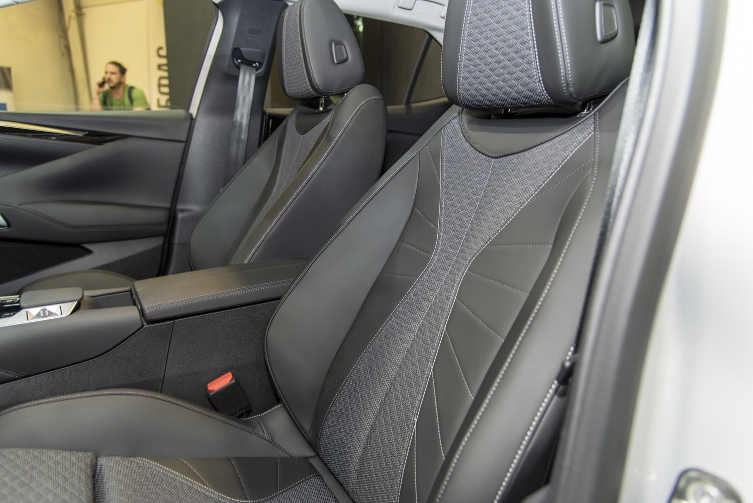 Close-up of luxury front seats with premium fabric and leather upholstery.