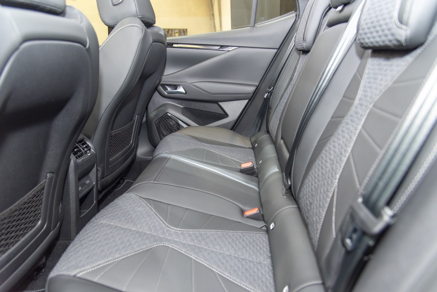 Rear seat interior with leather and fabric upholstery