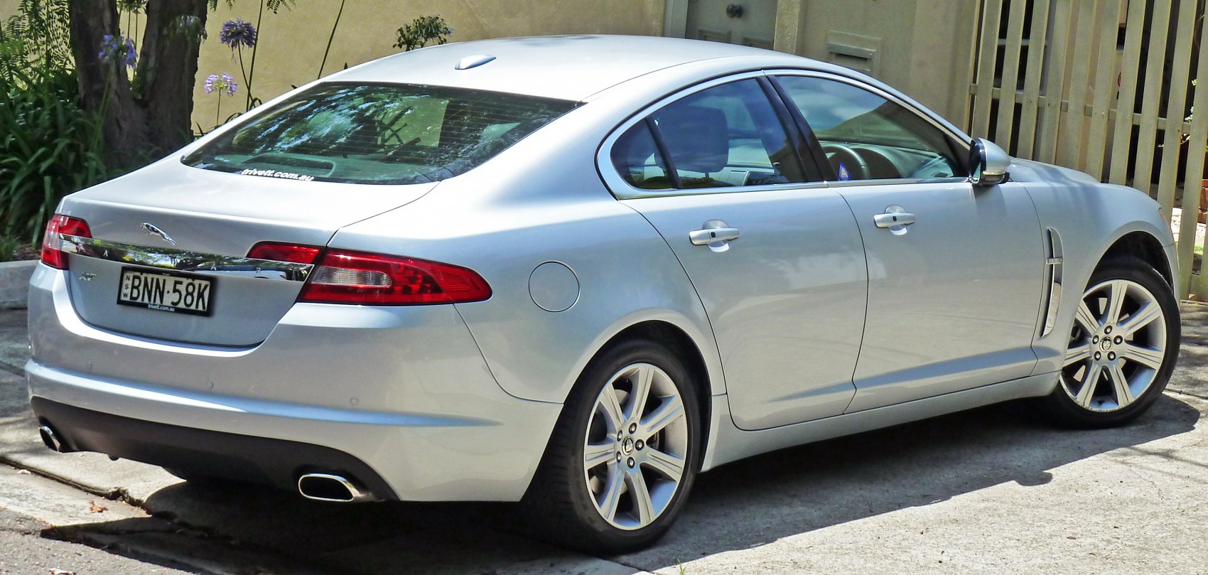 Luxury sedan rear with dual exhaust and alloy wheels