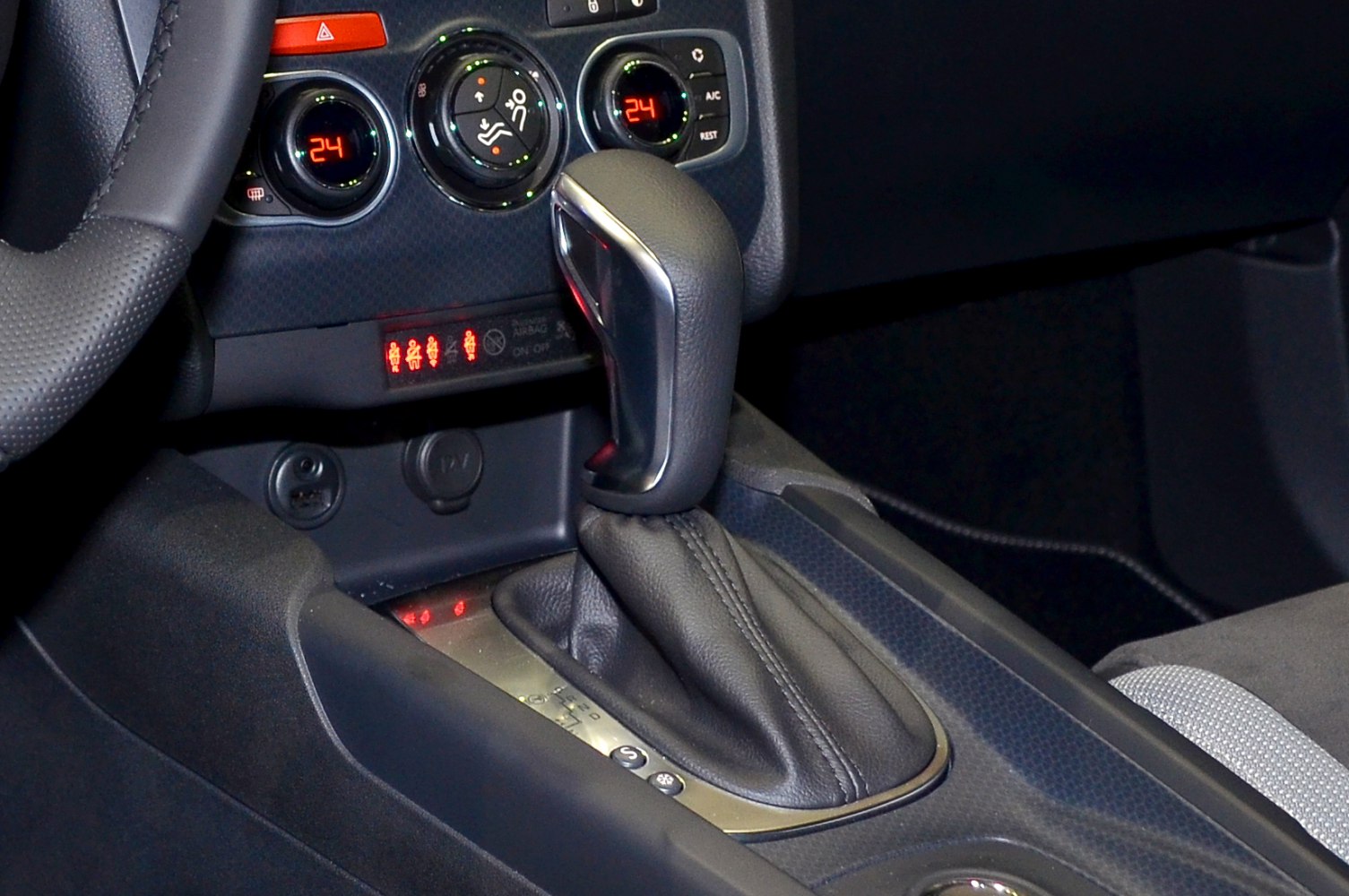 Automatic gear shift lever and climate control dials in car interior