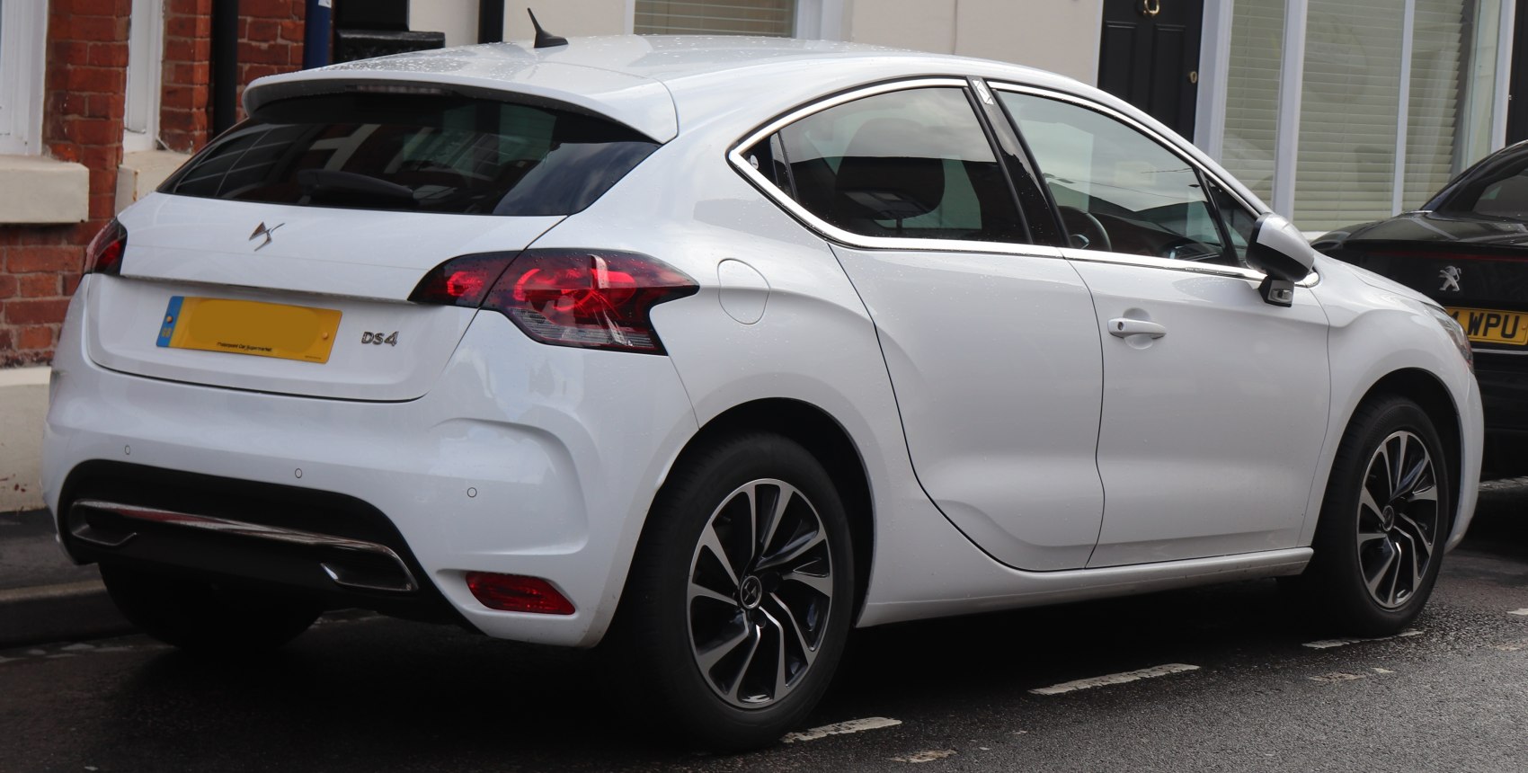 Rear hatchback view with tail lights and alloy wheels