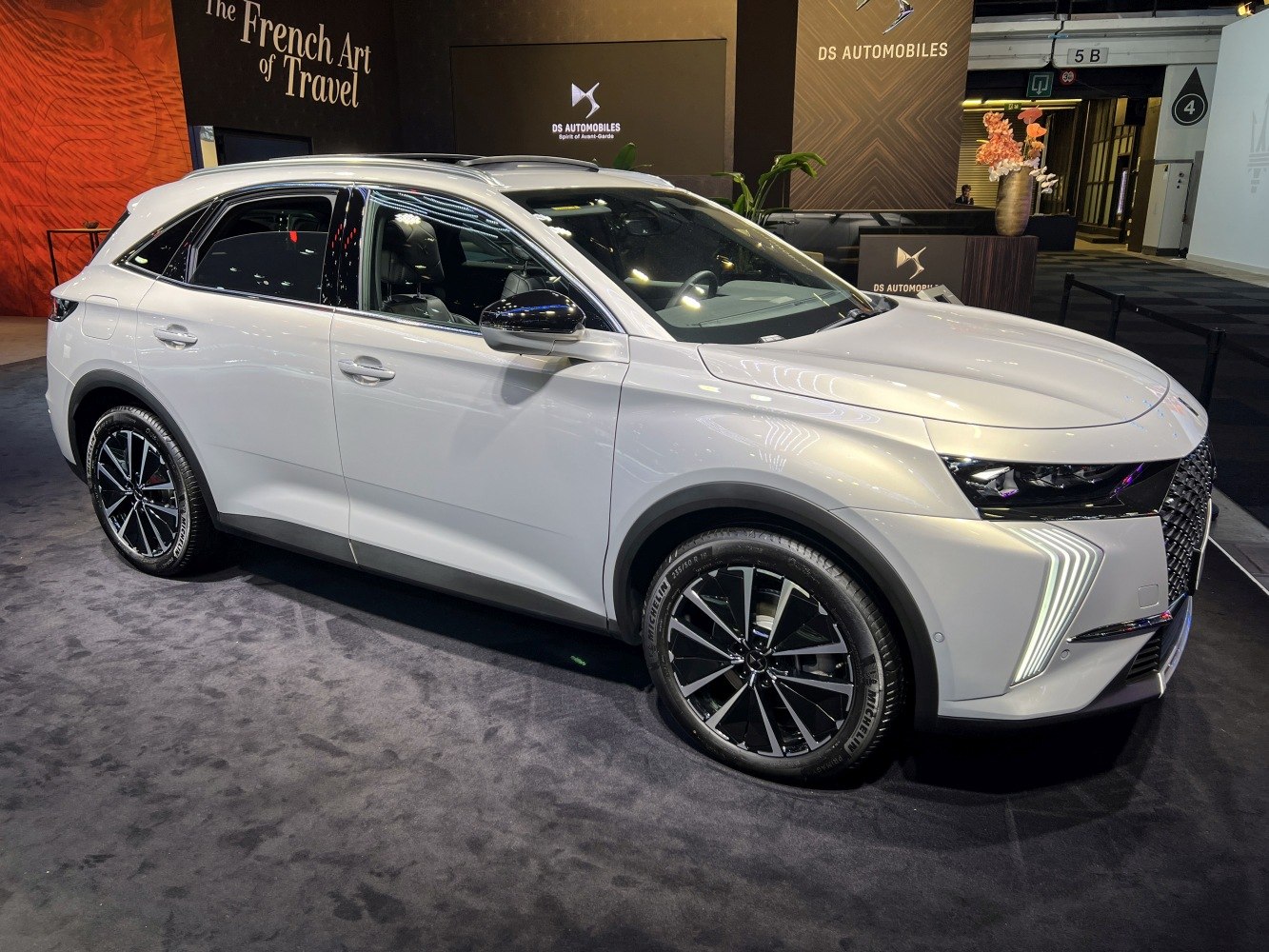 Front side view of modern SUV with sharp LED daytime running lights and alloy wheels