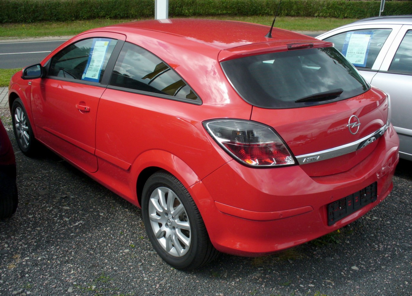 Rear view of a compact hatchback with notable rear lights and spoiler.