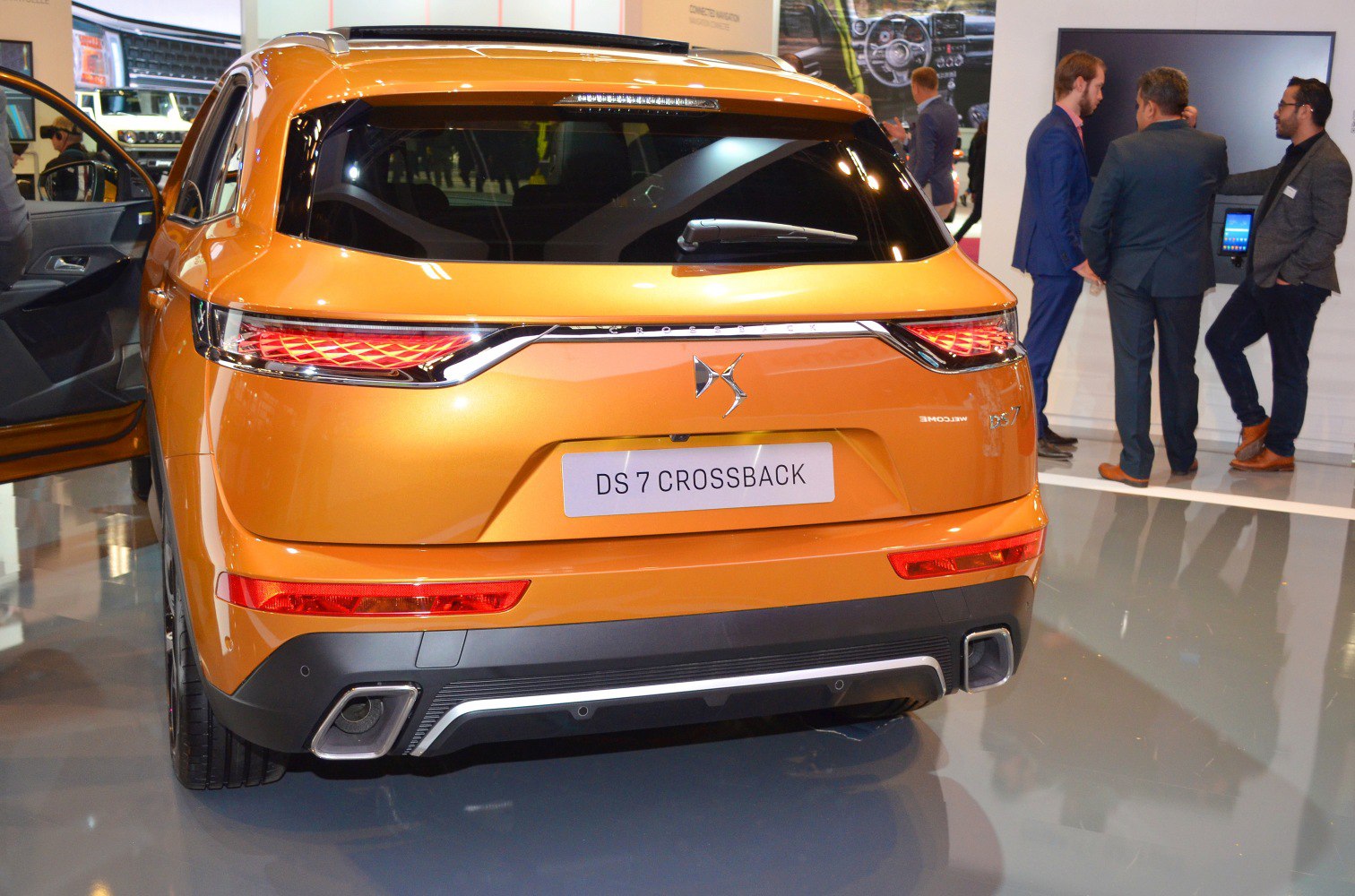 Distinctive rear tail lights and dual exhaust design in metallic orange finish