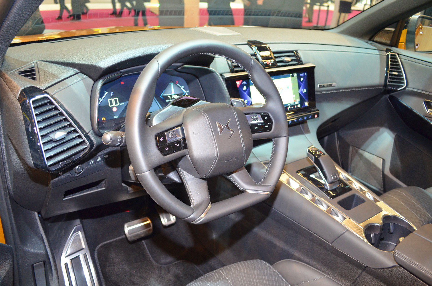 Unique multi-spoke steering wheel and digital dashboard inside a modern vehicle