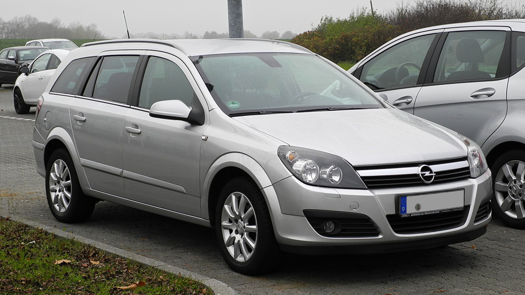 Silver station wagon front-side with alloy wheels and roof rails