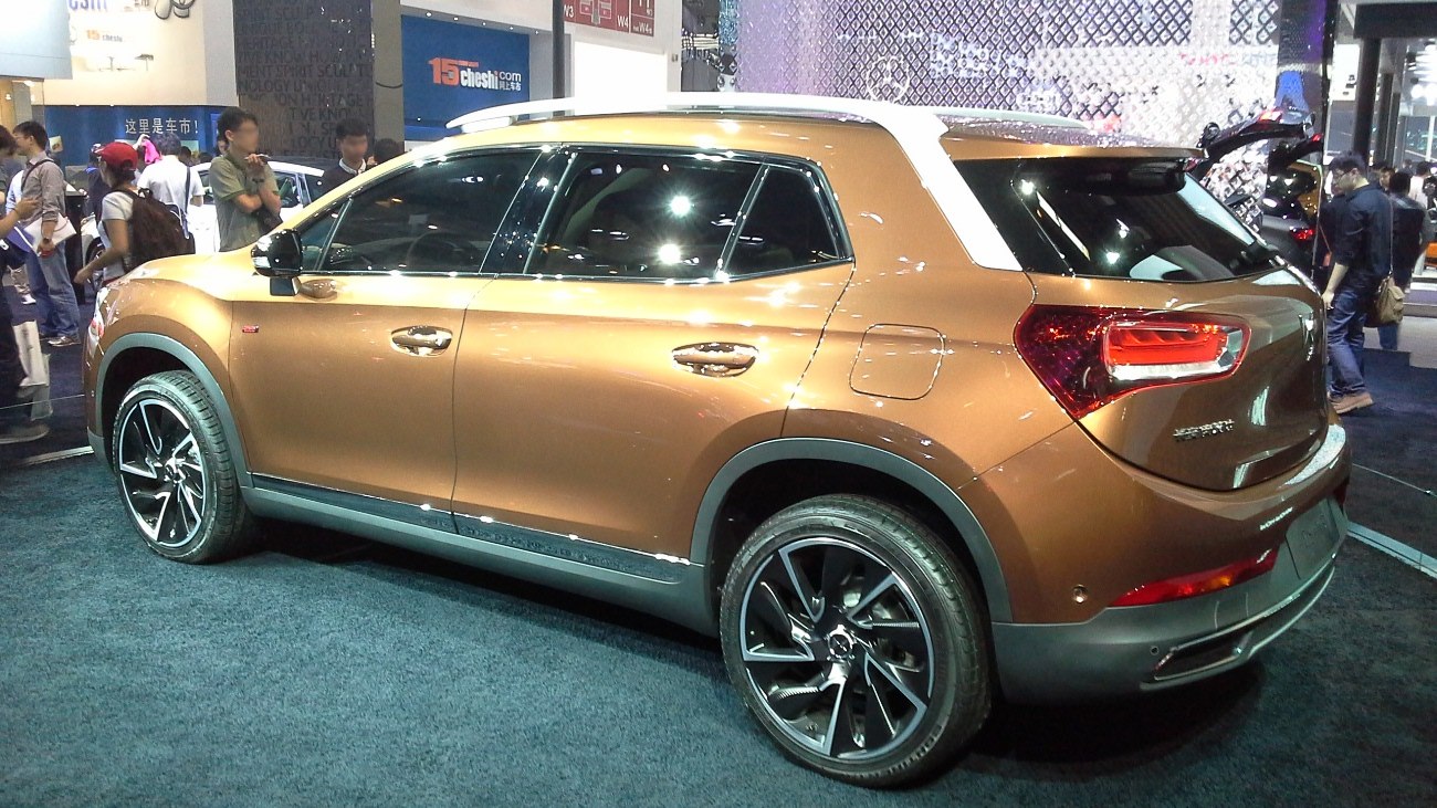 Brown two-tone SUV side profile with white roof and distinctive rear lights