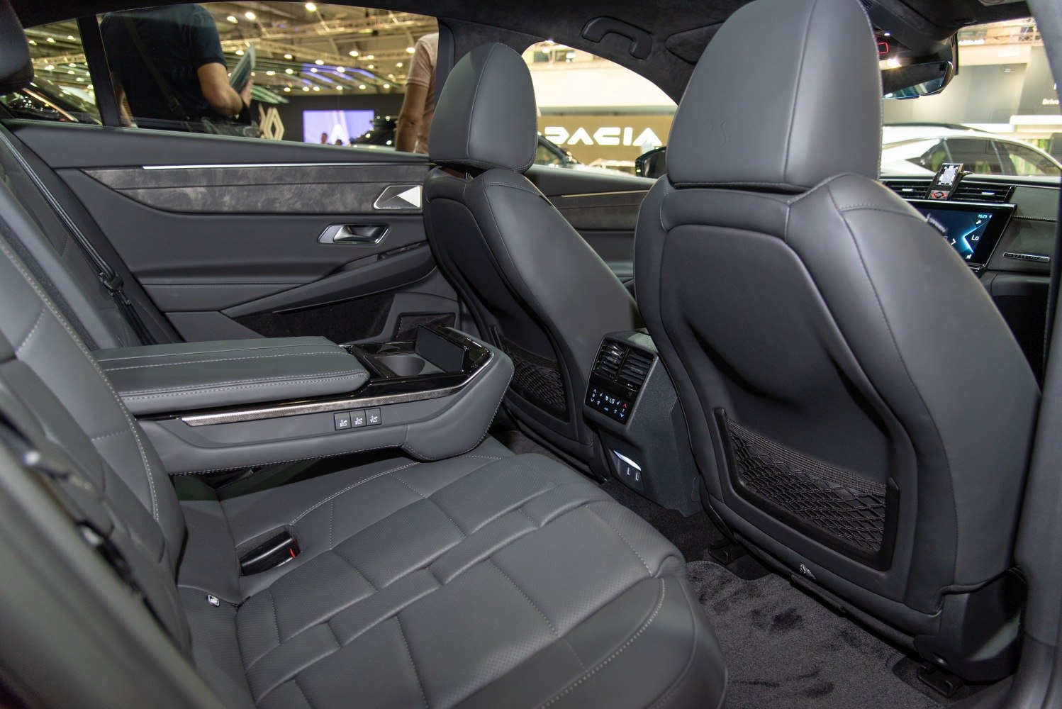 Rear seats with leather upholstery, armrest controls, and climate control panel