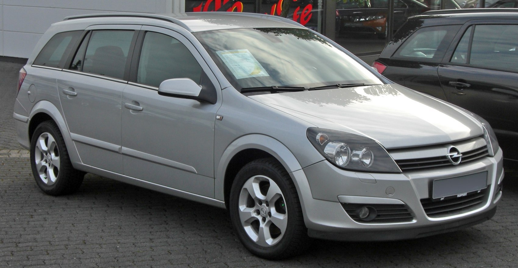 Silver station wagon front-side with alloy wheels and modern headlights
