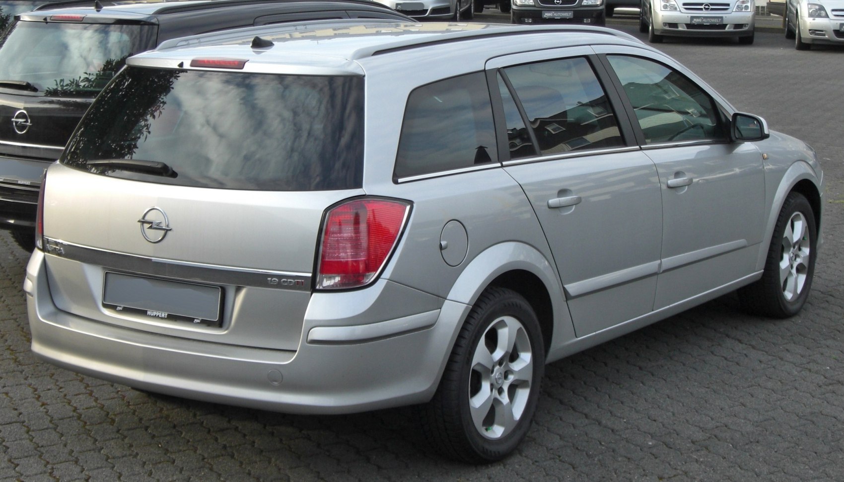 Silver station wagon rear view with tinted windows and distinct taillights