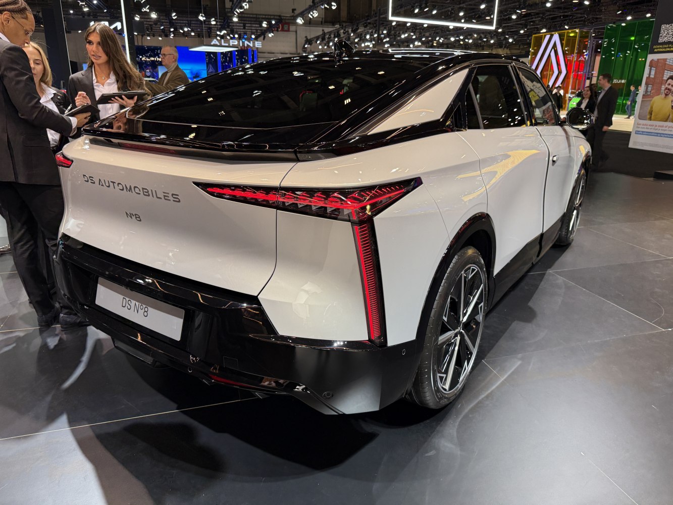 Rear view showcasing vertical LED tail lights and black roof contrast