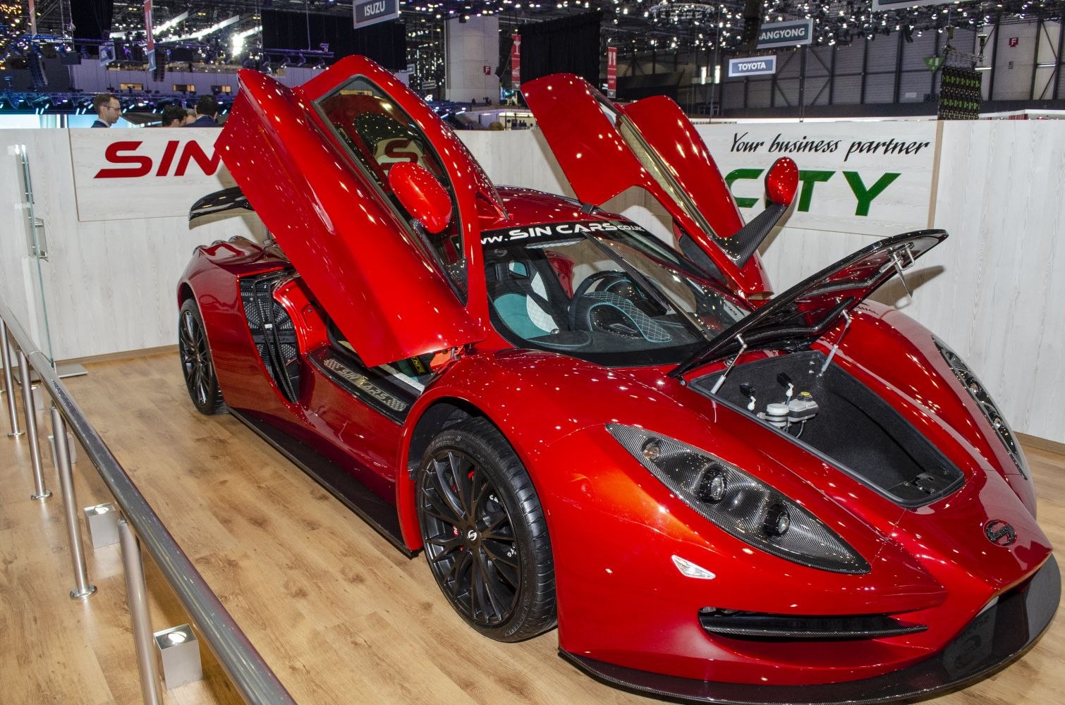 Red sports car with butterfly doors and open front trunk