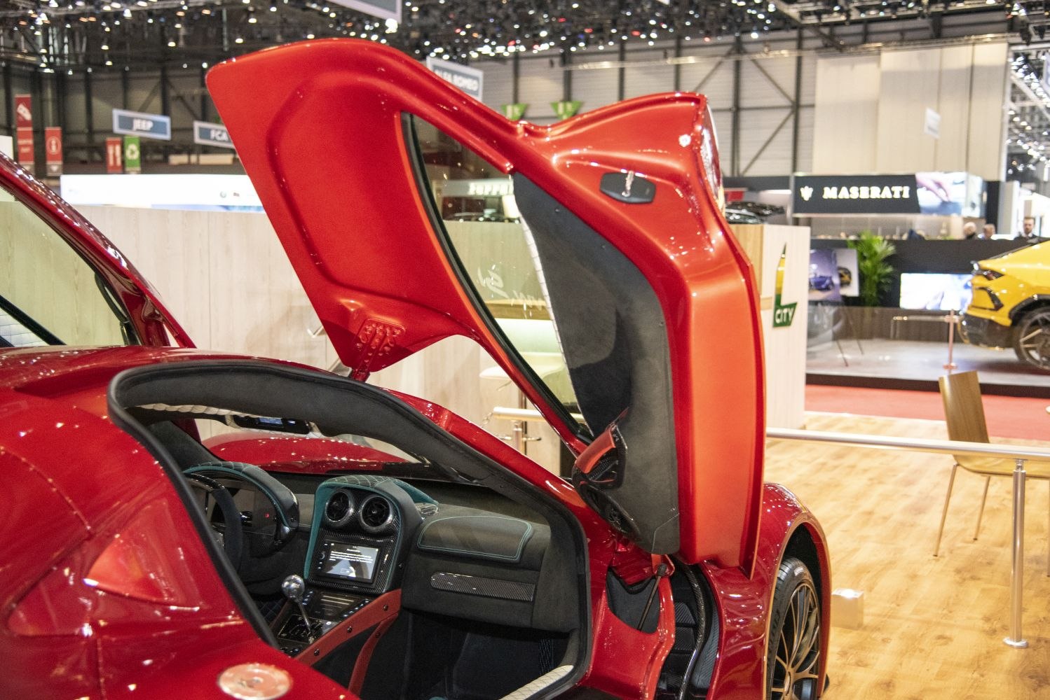 Butterfly doors opening to reveal high-tech dashboard and sporty interior