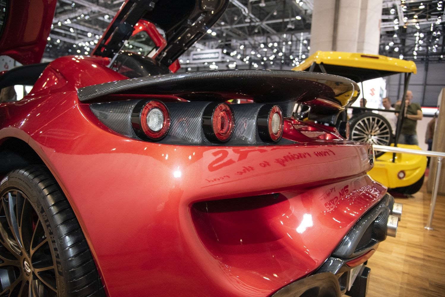 Rear with triple circular taillights and carbon fiber spoiler