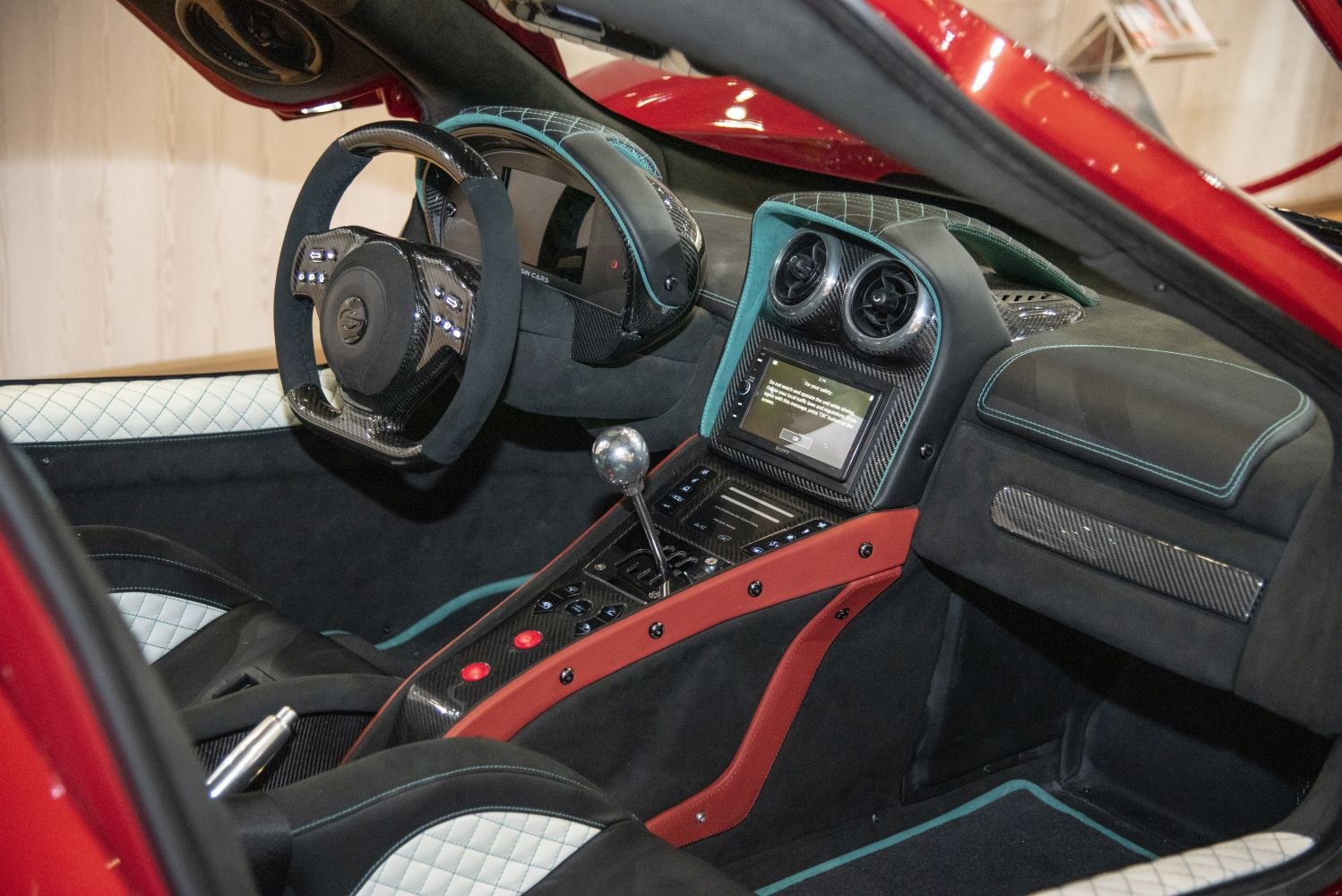 Carbon fiber detailed racing interior with digital dashboard and manual gear lever