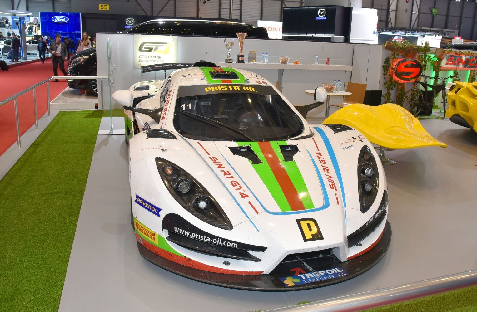 Front and top view of a GT4 racecar with aerodynamic design and racing livery