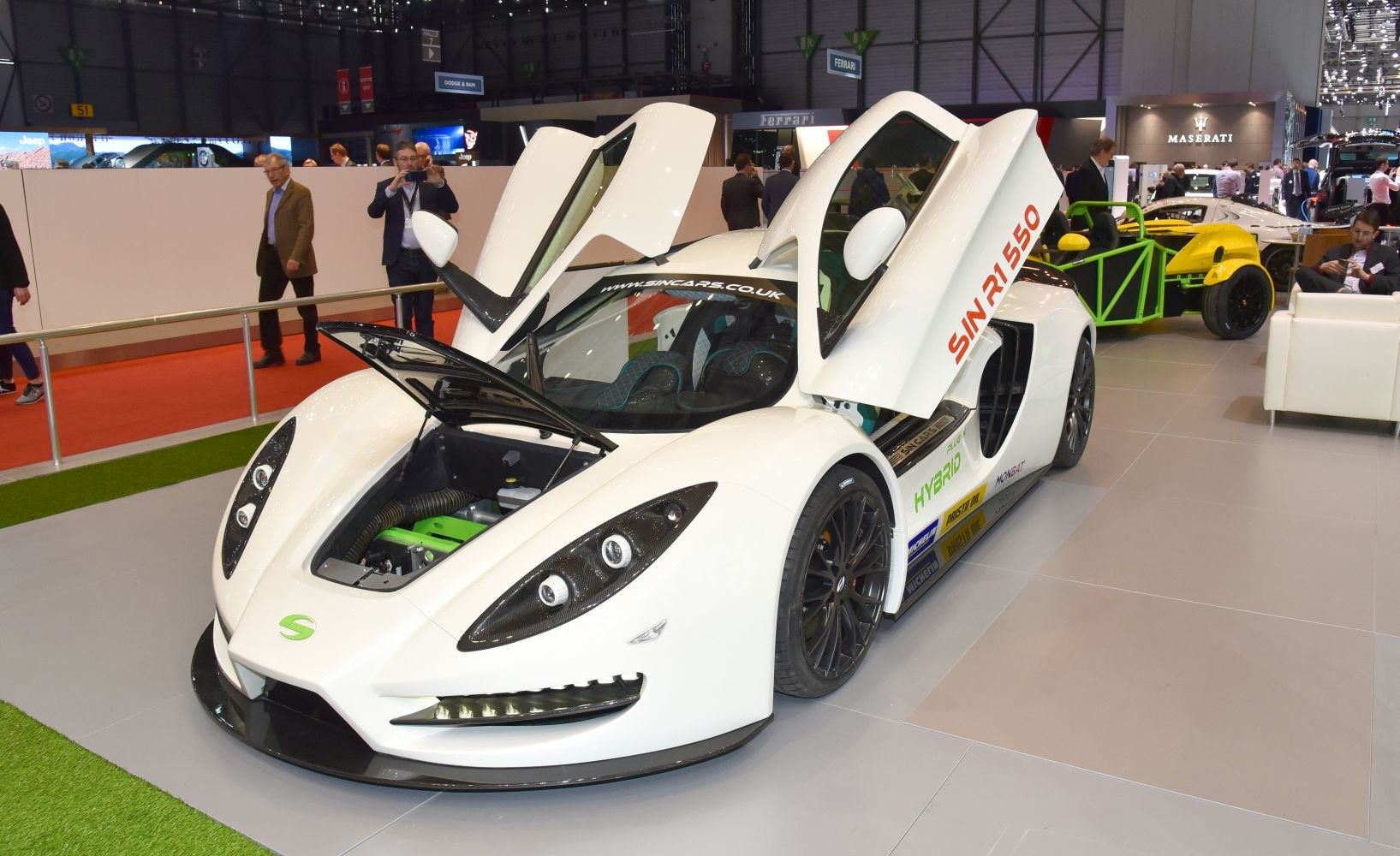 White sports car with butterfly doors and front trunk open